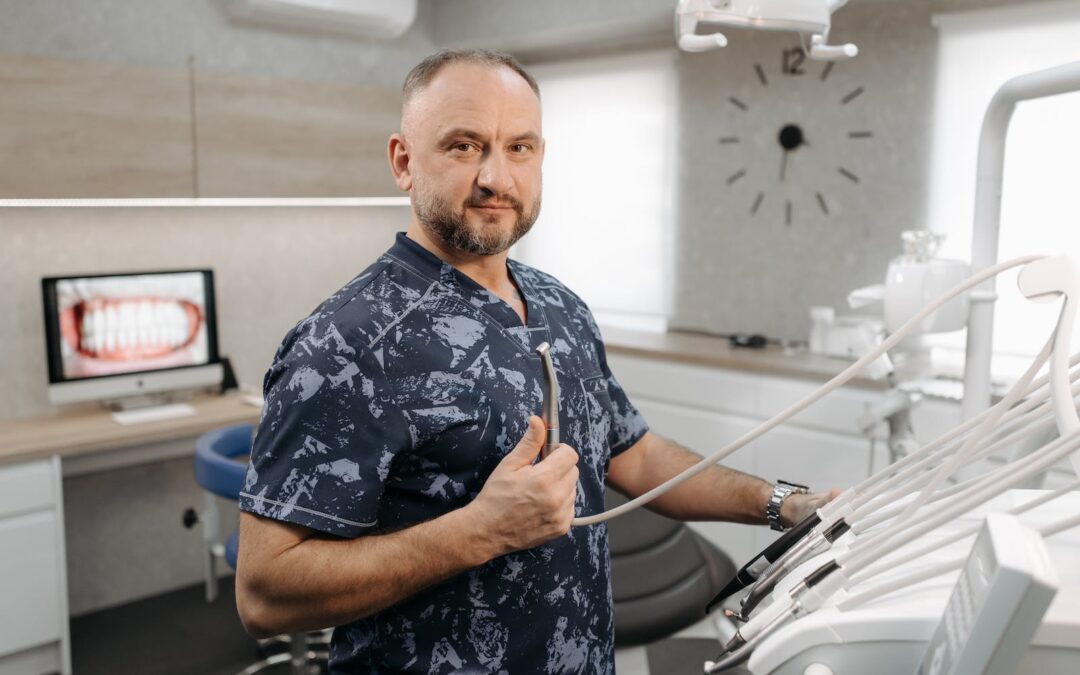 A Dentist Holding a Dental Instrument